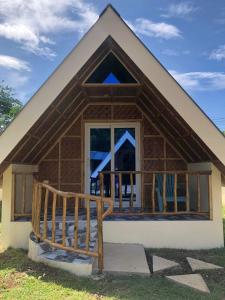 a house with a porch and a balcony at Dwarf Guest House in Siquijor