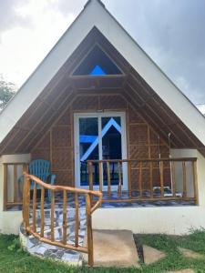 a small house with a porch and a balcony at Dwarf Guest House in Siquijor