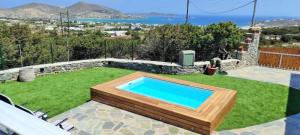 a swimming pool in the middle of a yard at The old barn, Naousa Paros in Naousa
