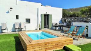 a backyard with a swimming pool and a house at The old barn, Naousa Paros in Naousa