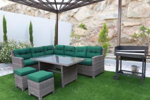 a patio with a couch and a table and a piano at شاليهات صن سيت تايم in Khamis Mushayt