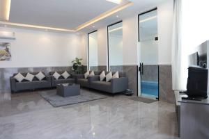a living room with a couch and a tv at شاليهات صن سيت تايم in Khamis Mushayt