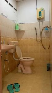 a bathroom with a toilet and a sink at Berkat Pak Raja Homestay Mergong Alor Setar 