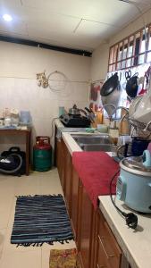 a kitchen with a sink and a counter top at Berkat Pak Raja Homestay Mergong Alor Setar 