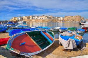 a group of boats are docked in a harbor at La Casa del Turista in Gallipoli