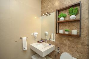 a bathroom with a sink and a mirror at The Mark in Islamabad +37 photos