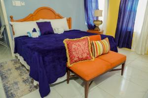 A bed or beds in a room at A taste of Jamaica Lavern’s Place