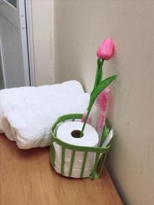 a pink flower in a basket on the floor at Lucky Home in Nha Trang