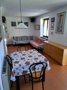 a living room with a table and chairs and a couch at Casa bianca in Malè