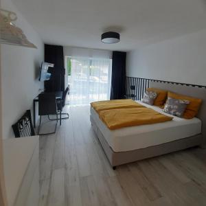 a bedroom with a bed and a desk in it at Apartment Kampenwand in Aschau im Chiemgau