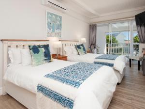 two beds in a room with a window at Oude Schuur Boutique Guesthouse in Hermanus +112 photos