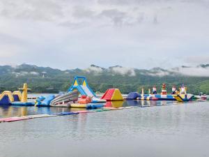 a group of inflatable rides on the water at เดอะวอเตอร์ปาร์ครีสอร์ท- The Water Park Resort in Ban Laem Mong Khoi