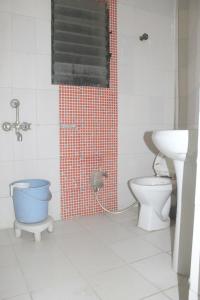 a bathroom with a shower and a toilet and a sink at Hotel Preetam Aurangabad in Aurangabad