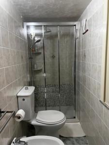 a bathroom with a toilet and a glass shower at Da Nonno Antonio in Santa Teresa di Riva