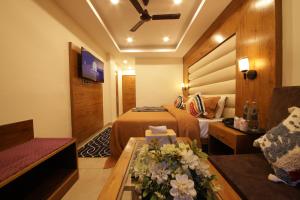 a hotel room with a bed and a couch at PerfectStayz Mall Road Mussoorie in Mussoorie