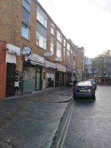 a car parked on a street in front of a building at Self contained 2 Bedroom flat in Southwark in London