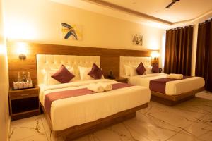a hotel room with two beds in a room at PerfectStayz Mall Road Mussoorie in Mussoorie