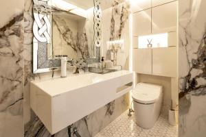 a white bathroom with a sink and a toilet at Reimi Mondo602 in Tokyo