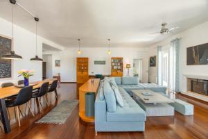 a living room with a blue couch and a table at Big Blue in Piso Livadi