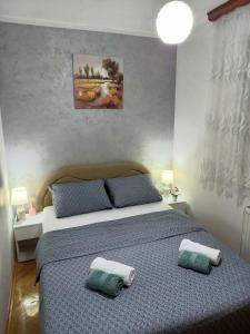 a bedroom with a bed with two pillows on it at Apartman Central in Bijeljina