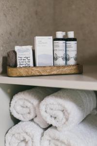 a shelf with towels and other products on it at Limeria studios & maisonettes in Parga