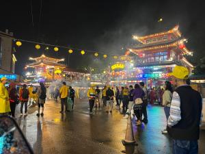 a group of people walking down a street at night at 享窩民宿 -可包棟 in Jian