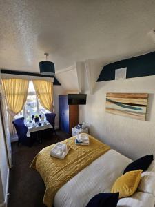 a hotel room with a bed and a desk at The Tilstone Guest House in Llandudno