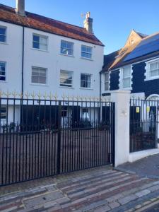 a black fence in front of a white house at Number Three in Brighton & Hove
