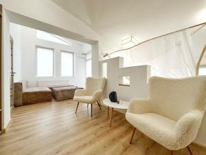 a living room with two chairs and a table at Higina Spa Hotel in Truskavets