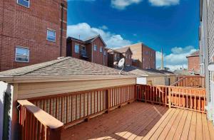a wooden deck with a roof on a building at Lovely home near Chicago hospitals, White Sox Park, and McCormick Place in Chicago