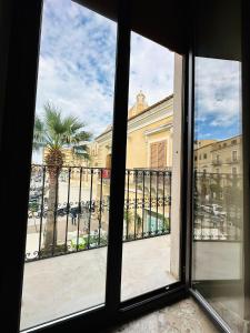 an open window with a view of a building at B&B - Piazza Grande in Gela