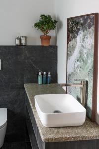 a bathroom with a white sink and a toilet at WITHIN THE VILLAGE in Galway