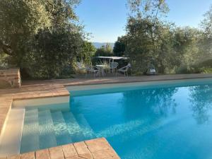 piscina blu con tavolo e sedie di Vesper - Casale con piscina - Ad Galli Cantum a Città della Pieve