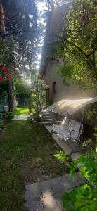 a house with a tent and a bench in a yard at Misevici vikendica in Sarajevo