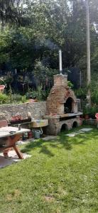a stone oven in a yard with a picnic table at Misevici vikendica in Sarajevo