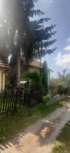 a house with a fence and a tree in front of it at Misevici vikendica in Sarajevo
