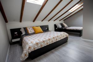 a bedroom with a bed in a room with skylights at Domus 25 in Catania