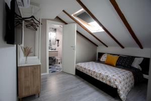 a bedroom with a bed and a skylight at Domus 25 in Catania