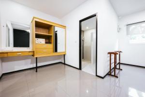 a room with a dresser and a mirror at Vivace Hotel in Kamala Beach