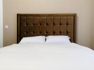 a large bed with two white pillows on it at Marina Apartments in Bradford