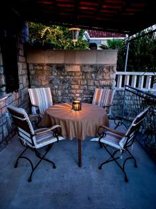 a table with two chairs and a candle on a patio at Garden Apartment in Selca +3 photos