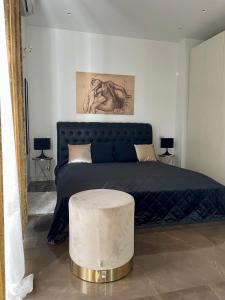 a bedroom with a bed with a blue blanket and a table at EUR suite BEETHOVEN in Rome