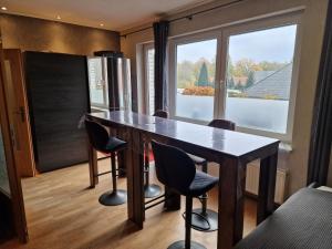 a kitchen with a table and chairs and a window at Haus der Erholung App OG in Lotte