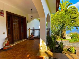 an entry to a house with a door and a porch at Drago Tree Villa Tenerife in La Orotava