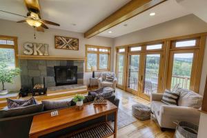 a living room filled with furniture and a fireplace at Huge Home w Studio Apt-Mountain Views-Hot Tub-Sauna in Ellicottville