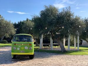 an old green and yellow van parked in a park at San marco 56 in Bari
