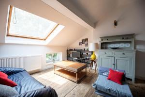 a living room with a blue couch and a window at Appartement Bronckart_10 in Liège