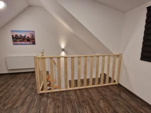 a room with a wooden staircase in a attic at Haus im Grünen in Stemwede