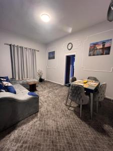 a living room with a bed and a dining room table at downtown Family Suites in Cairo