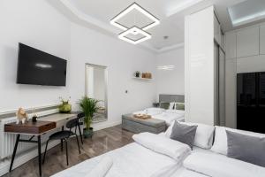 un soggiorno bianco con divano bianco e tavolo di Malila Premium Apartments Cracow Centre Starowiślna 43 a Cracovia
